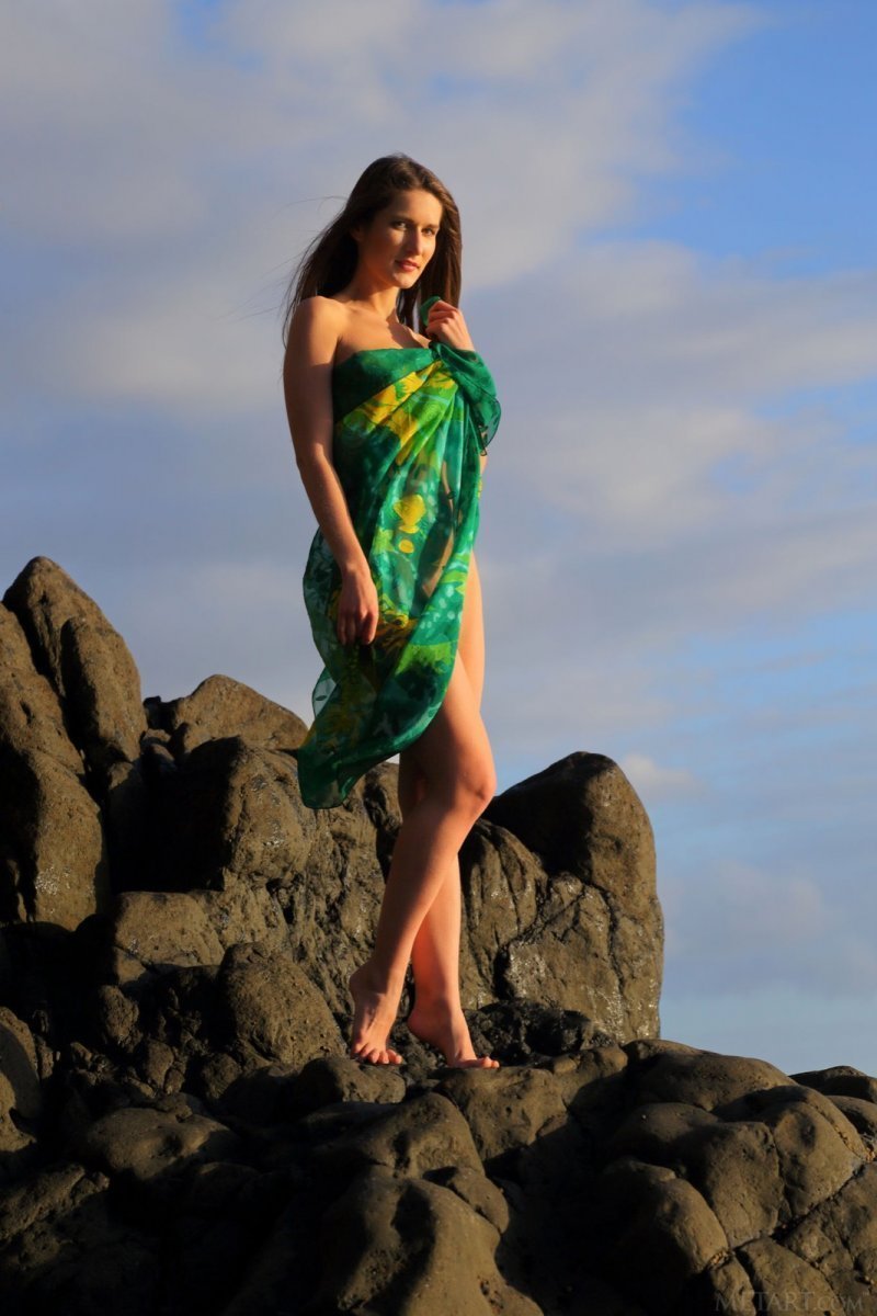 Naked woman poses beautifully on the seaside