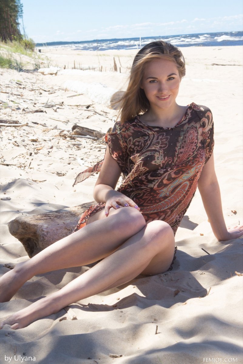 Beautiful erotica with a young woman on golden sand